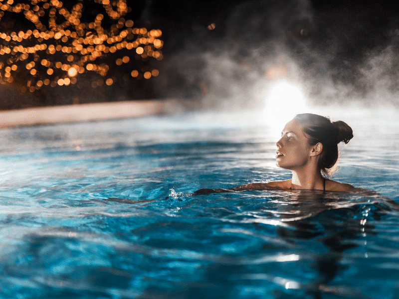 Relaxing in a heated pool at night in Sydney
