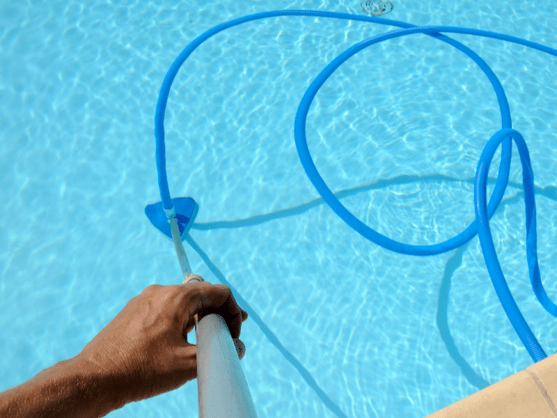 Cleaning a Sydney swimming pool using a suction pool cleaner